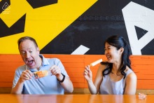 Joyful Couple Enjoys A Sweet Treat Eating Popsicles During A Casual Engagement Photography Session In Atlanta Georgia While visiting the bustling Ponce City Market in Atlanta, Georgia, this joyful couple enjoys a sweet treat by eating popsicles together during their casual and fun engagement photography session.