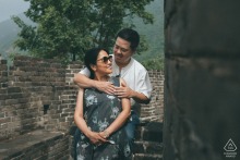 On the Mutianyu Great Wall in Beijing, the couple appears in a composed portrait of togetherness, framed by ancient stone lines, sweeping views, and timeless connection.