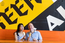 Colorful Murals And Popsicles Brighten Ponce City Market In Atlanta, Georgia Engagement Session A couple poses with popsicles against a bold mural during their pre-wedding engagement session at Ponce City Market in Atlanta, Georgia.