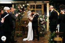 The newlyweds share a loving embrace at the end of their ceremony at Clapton Country Club in London, England, celebrating their union with a heartfelt hug in front of family and friends.