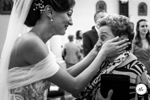 Following the ceremony in Udine, Friuli Venezia Giulia, Italy, the bride shares a deeply emotional moment with her grandmother, connecting generations in a tender embrace.