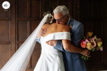 At Fanhams Hall, the father of the bride warmly embraces his daughter, providing a moment of comfort, love, and support during her wedding day.