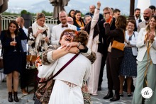 At Domaine des Saints Pères in Montagnole, Savoie, France, a joyful aunt shares a happy embrace with the bride after catching the bouquet at the reception.