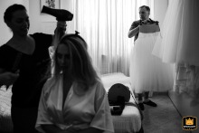 At a wedding in Livorno, Tuscany, Italy, a funny moment was captured when the bride's father held her dress in the getting ready room, earning the photographer a WPJA Spotlight award.