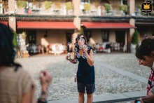 At Cascina Carretto, Erbusco, a guest joyfully plays with soap bubbles, adding a whimsical touch to the celebration.