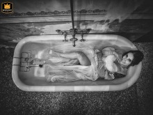 At Savona Villa Spagnuola Gavotti, the bride smiles while lying in an empty vintage bathtub, captured from directly above.