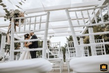 Ca' Borghese Ameglia couple seen through a chair back at their wedding ceremony location.