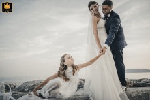 San Terenzo, La Spezia: Newlyweds and daughter share love on beach; family portrait.