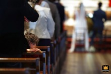 Child in a French church, Tarn-et-Garonne, Occitanie, watching behind him during a wedding.