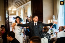 Groom enters Villa Fassati Barba dining room, guests erupt in joyous cheers.
