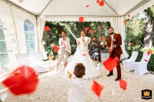 The bride and groom joyfully celebrate their marriage at Bastide des Jaillans, France, with exploding confetti cannons.