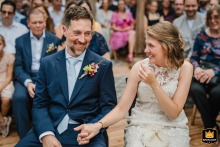 A joyful wedding moment in Düsseldorf, Germany: the happy couple shares a laugh during their ceremony.