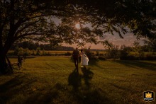 At Domaine William Wentworth, Drummond, QC, Canada, the bride and groom frolic in the rural countryside at sundown.