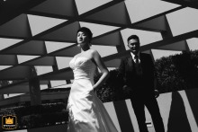 Newlyweds pose stylishly beneath striking geometric shadows at Portman Ritz-Carlton, Shanghai, China, exuding modern elegance together.