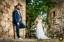In Puycornet, Tarn-et-Garonne, a newlywed couple is photographed on a typical street, standing before stone houses.