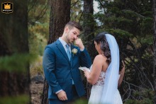In South Lake Tahoe, CA, alone in the woods, the bride reads vows as the groom wipes away tears.