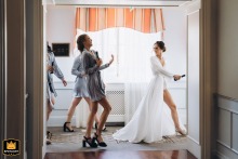 In the Bride’s Suite at the Four Seasons Hotel in Orange County, the bridal party enjoys a playful "bar dash" in their robes, capturing the fun and excitement as they celebrate together before the wedding.