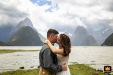 In Milford Sound, Fjordland National Park, New Zealand, the newlyweds share a passionate kiss. The intimate image captures their joy as husband and wife.