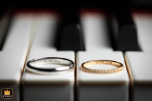 Wedding Rings Rest Elegantly on Piano Keys, Showcasing Classic Detail in Vienne, France Wedding Photo Wedding rings rest on the black and white keys of a piano in Vienne. The image captures a classic and elegant detail of the wedding day.