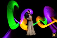 Night reception at The Fort Garry Hotel, a couple stands, encircled by a glowing light trail from a sparkler.