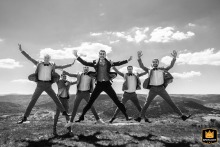 Groom and groomsmen joyfully leap atop a mountain, before heading to the church.