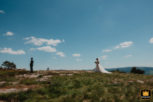 Bride's arrival behind the groom on a mountaintop in the Swiss Alps, moments before he turns.