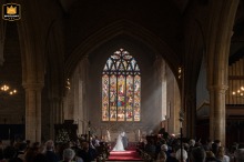Love’s Light Shines on the Newlyweds Praying at Olney Church’s Altar Bride and groom kneel at the altar for prayers as sunbeams stream through the windows of Olney church.