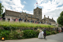 Bride and groom wave to guests leaving the scenic Wing church in Rutland, walking away into their new life.