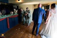 Award-winning photographer expertly captures the wedding ceremony at The Cliftonville Hotel, Cromer, Norfolk, UK. The image beautifully portrays the struggles with a confetti cannon.