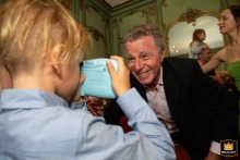 Capturing a Grandfather's Love: A Child's Unique Perspective in Buenos Aires A photographer captures a child taking a photo of his grandfather at the Alzaga Unzué Mansion in Buenos Aires, Argentina.