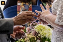 Atlanta, Georgia. A bride adjusts her new wedding ring with her husband's hand reaching in.