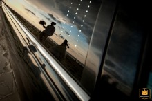 Long Beach Limo Reflects Newlywed Couple On Their Wedding Day Bride and groom are reflected in a limo's window in Long Beach, Mississippi, on their wedding day.