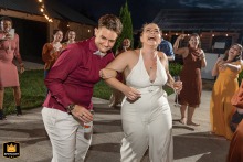 A farm near Cartersville, Georgia, provides the rustic setting where the newlywed couple is captured in a joyous, candid moment, dancing and laughing together.