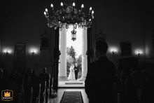 Poland: The anticipation is clear on the groom's face as he waits at the altar inside the church while his bride walks down the aisle accompanied by her proud father.