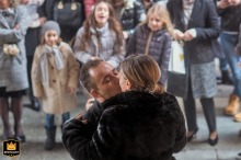 In Ravenna, Emilia Romagna, Italy, outside the town hall, kids joyfully toss rice as the newlyweds share a kiss, creating a lively and classic celebratory scene bursting with happiness and tradition.
