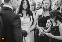 At the Renaissance Cleveland Hotel, Cleveland, OH, the couple stands together in a moment of sincere prayer during their ceremony, enveloped in a peaceful and reverent atmosphere as they share this meaningful time.