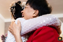 At home in Taiyuan, Shanxi, the bride shares a warm embrace with her mother, whose face radiates happiness and pride, capturing a tender bond on this special day.