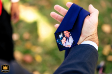 At Union Trust in Philadelphia, a detail shot captures the father’s tie adorned with a small photo of his daughter, symbolizing his love and connection as he prepares to give her away, emphasizing sentiment and cherished family bonds.