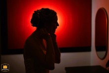   In Philadelphia, a silhouetted figure pauses quietly, the interplay of light revealing a mix of nerves and anticipation just before the wedding begins.