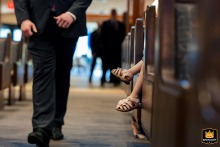 Groomsman and Child Add Innocence to Ceremony at Congregation Etz Chaim in Atlanta Inside Congregation Etz Chaim, a groomsman enters the synagogue while a child’s small legs dangle playfully into the aisle, adding a touch of innocence to the ceremony.