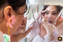 A Georgia bride puts on her contacts A Georgia bride puts on her contacts in a mirror before wedding ceremony.