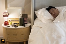 During a quiet moment labeled as sleeping time, a guest or wedding party member rests at the peaceful Nai Lert Park Heritage Home in Bangkok before the festivities.