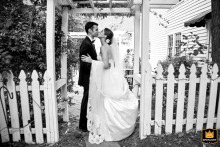 Couple Stands Beneath Archway At Kimball Hall In Roswell, Georgia The bride and groom stand together beneath an archway at Kimball Hall in Roswell, Georgia, creating a classic wedding-day image framed by the venue’s architecture.