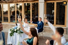 Guests Raise Glasses For Opening Toast At Borgo La Caccia In Pozzolengo, Italy Guests raise their glasses for the opening toast at Borgo la Caccia in Pozzolengo (BS), Italy, marking the start of the wedding dinner and evening celebration.