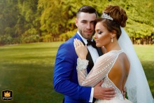 The couple shares a peaceful embrace in the natural surroundings of Bucharest, Romania, highlighting their connection and the quiet intimacy of their wedding day.