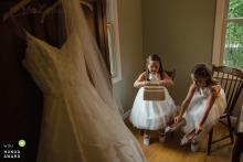 Documentary wedding photograph of two young bridesmaids preparing their shoes and purses at Annapolis