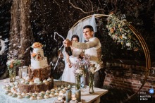 Vercelli Wedding at Castello di Moncrivello, Italy - Groom celebrating with a champagne spray at the cake table while the bride stands beside him