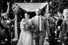 At Vignette Gardens, Miami, the bride and groom joyfully walk down the aisle together, exiting the ceremony as newlyweds.