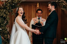 Laughter Fills the Air as Bride Lights Up During Vows at Norton Grounds in Gloucestershire England Laughter fills the air at Norton Grounds in Gloucestershire as the bride lights up during exchanges wedding vows.