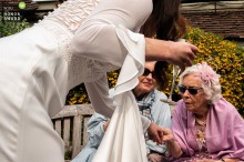 Bride Proudly Shows Her Ring to Elder Friend at Old Luxters Barn in Oxfordshire England A bride proudly shows off her ring to an elder friend at Old Luxters Barn in Oxfordshire.